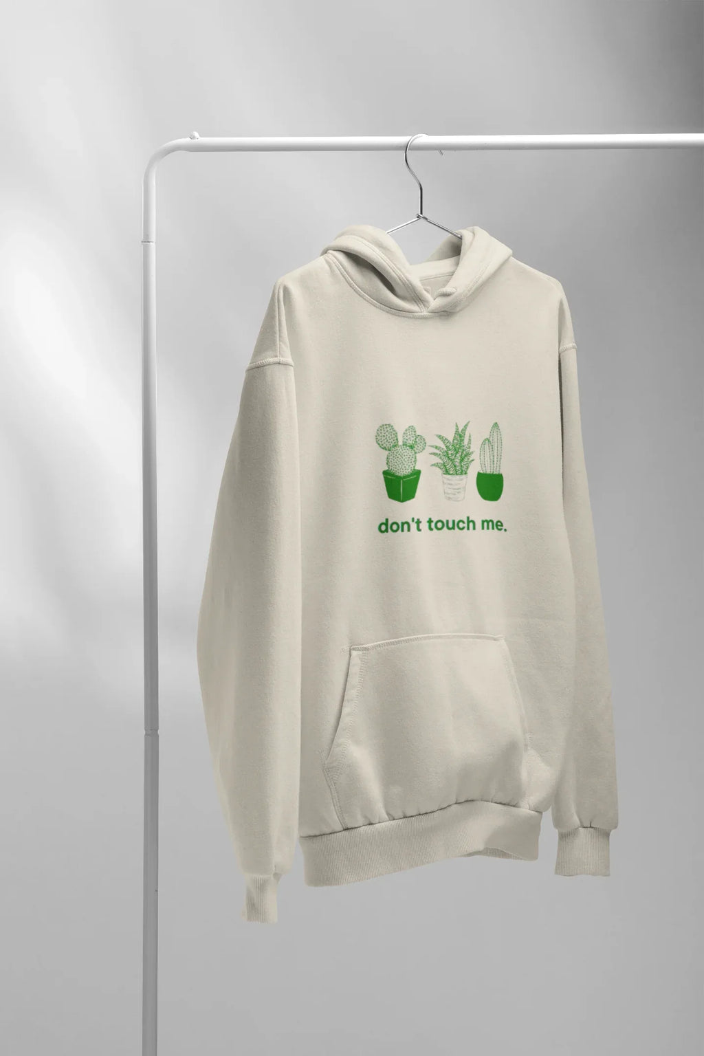 Cream hoodie with cactus graphic and “don’t touch me.” text on the front