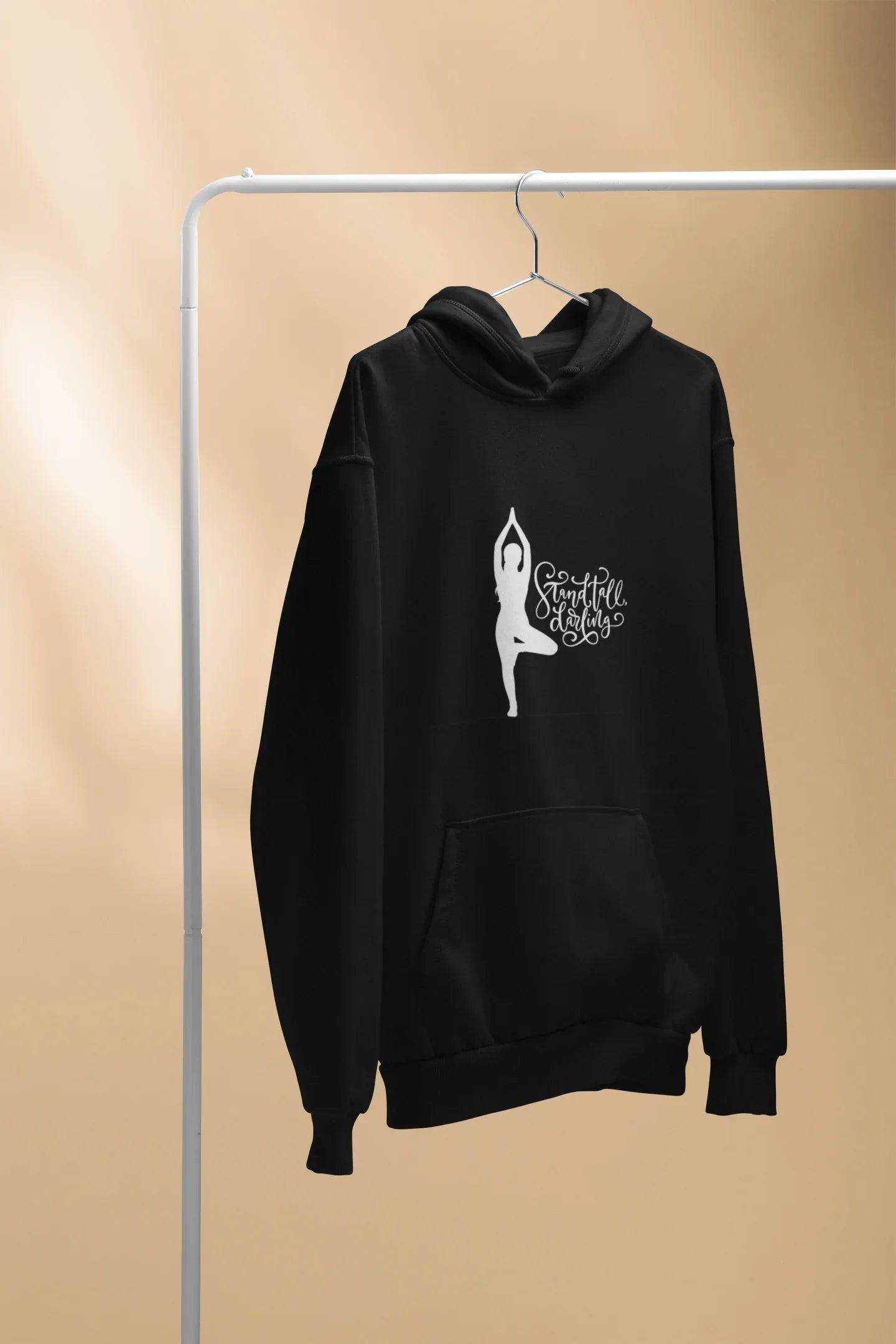 Black hoodie with front kangaroo pocket and hood, featuring a yoga silhouette graphic.