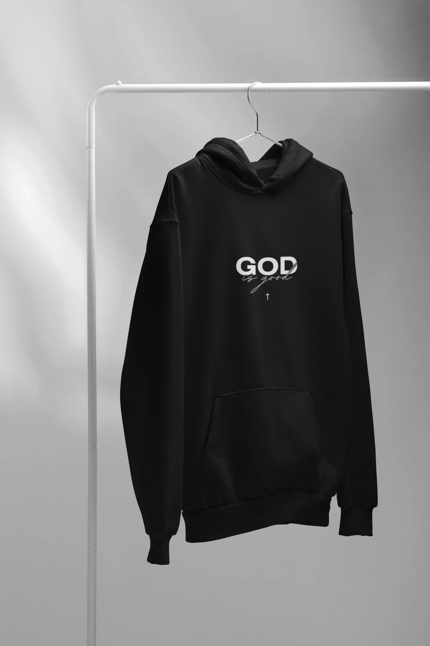 Black unisex hoodie hanging, 'GOD' logo and kangaroo pocket