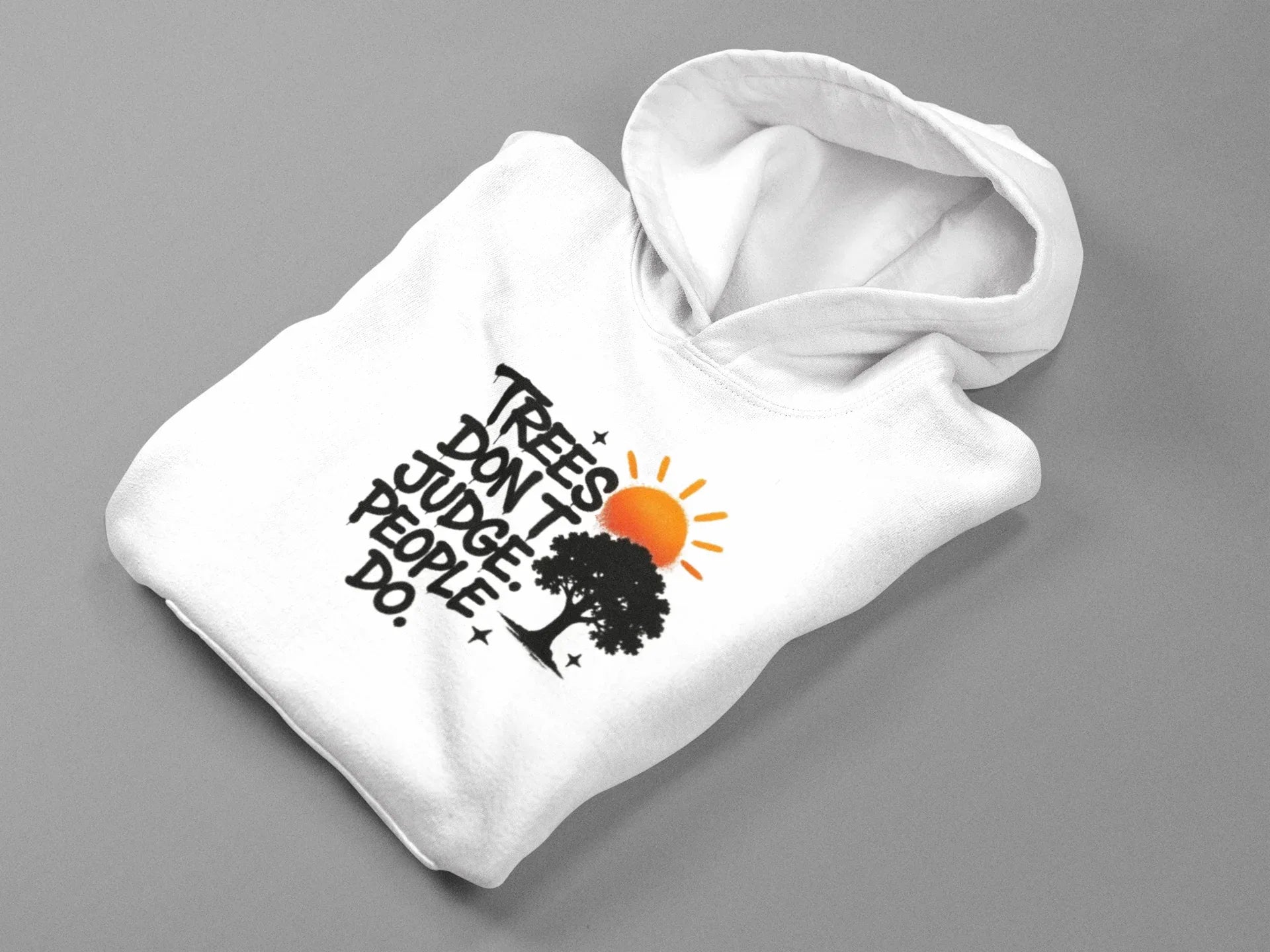 White pullover hoodie laid out, showing chest graphic with tree and text