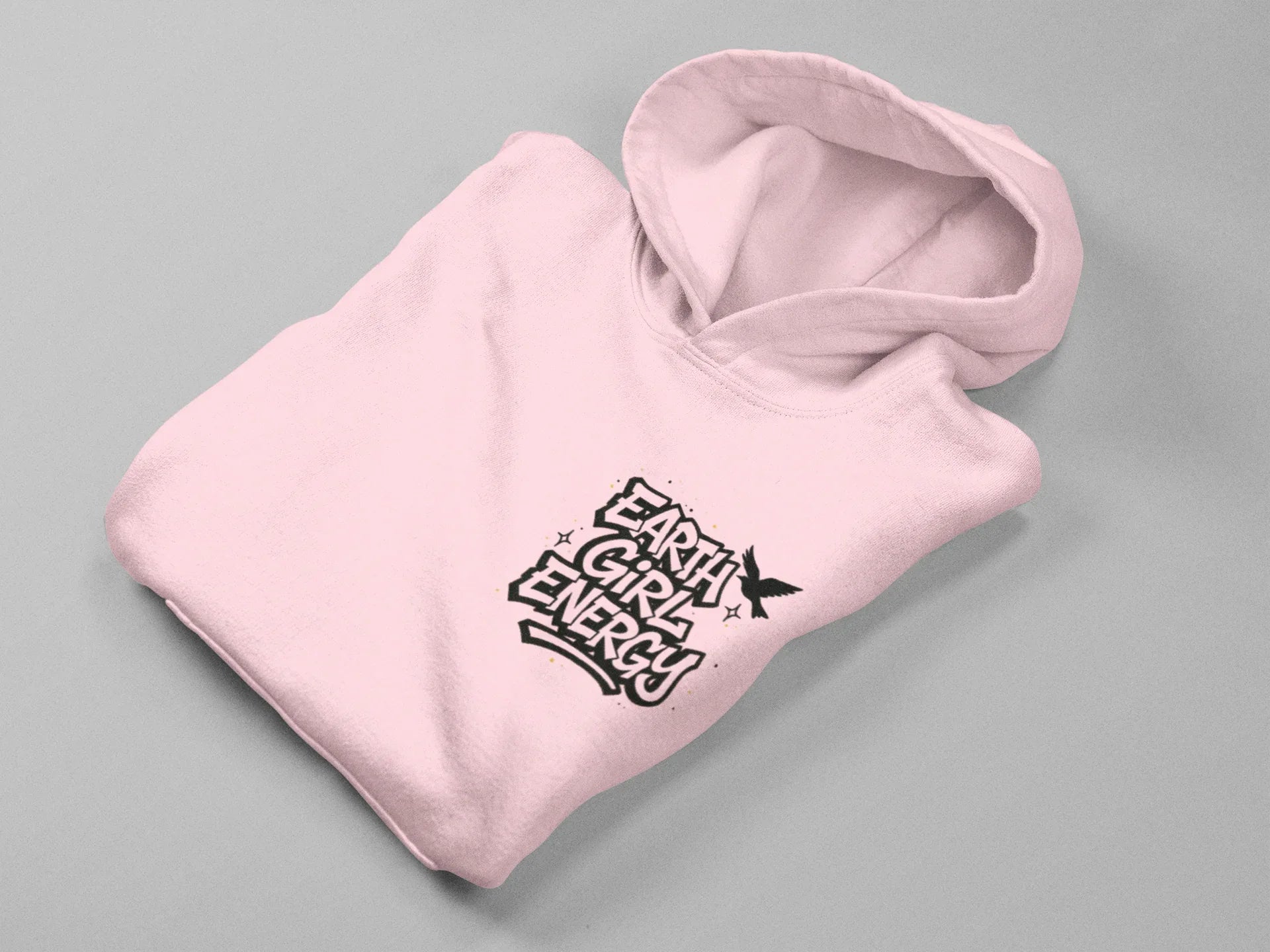 Pink hoodie laid flat with hood and Earth Girl Energy chest logo