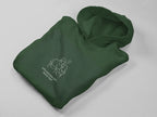 Forest green hooded sweatshirt folded with chest couple graphic