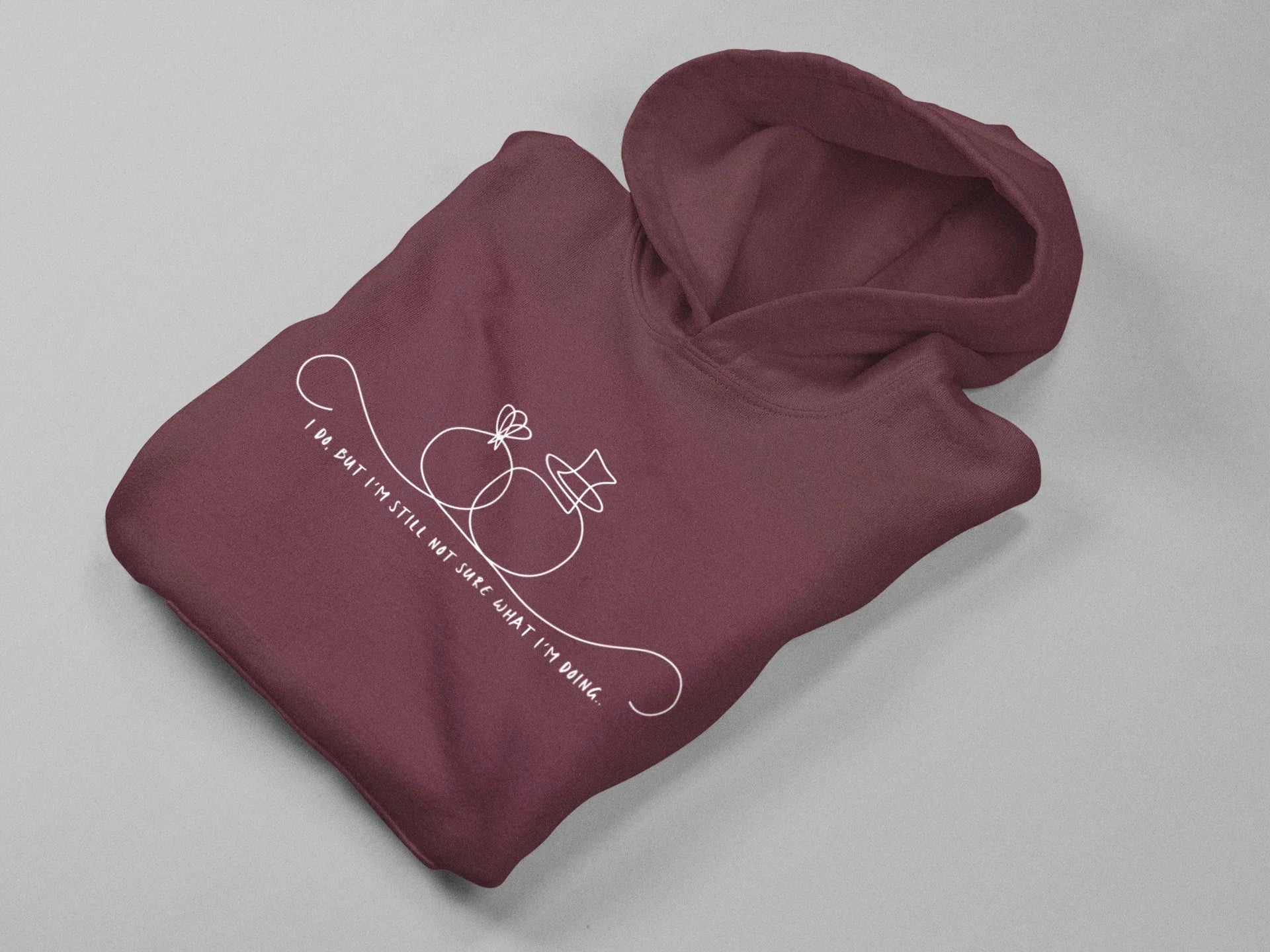 Maroon unisex hoodie, folded view, hood and pouch pocket with front line-art graphic