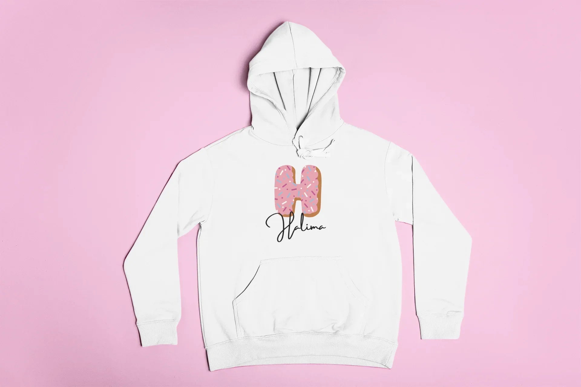White kids pullover hoodie with hood, front pocket, and pink donut graphic on center.