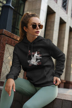 Black unisex hoodie with hood and chest graphic, model seated