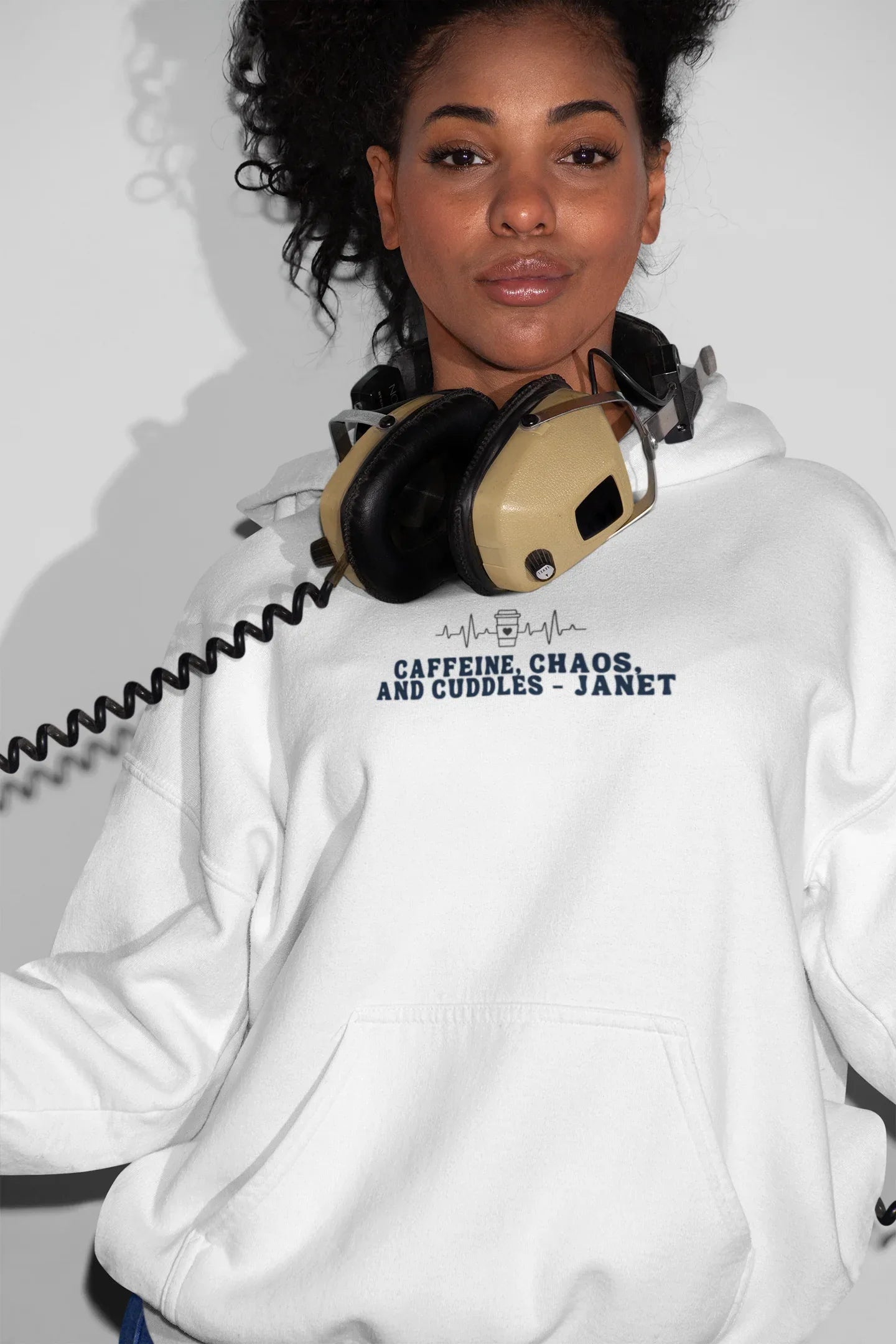 White hoodie sweatshirt with kangaroo pocket and 'Caffeine, Chaos, and Cuddles' chest graphic