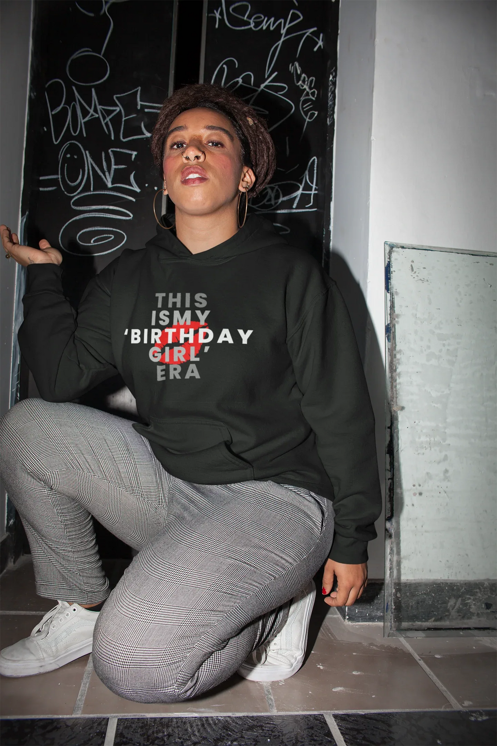 Black pullover hoodie on model, hooded sweatshirt with front "THIS IS MY BIRTHDAY GIRL ERA" print