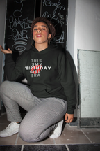 Black pullover hoodie on model, hooded sweatshirt with front "THIS IS MY BIRTHDAY GIRL ERA" print