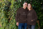 Brown unisex hoodies worn by two people, front line-art wedding rings graphic