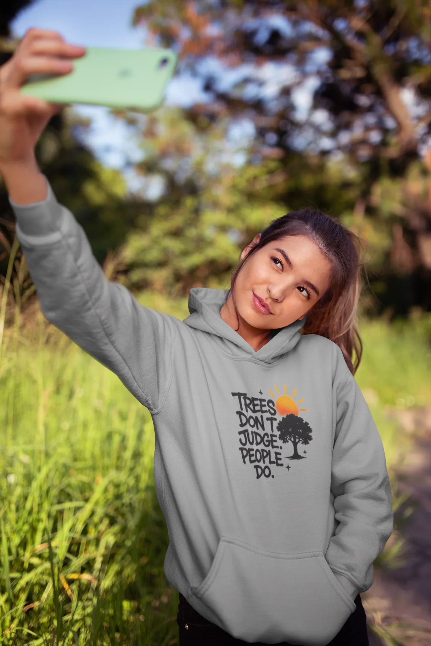 Sport grey hoodie worn outdoors, showing chest graphic with tree and text