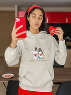 White pullover hoodie with drawstring hood and couple graphic on chest