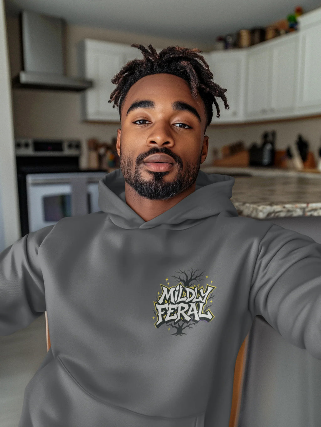 Dark gray graphic hoodie with a small chest “Mildly Feral” logo and front pouch pocket