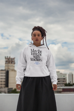 White hooded sweatshirt with front graphic text and blue book emblem, worn outdoors.