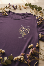 Purple crew-neck t-shirt with small floral bouquet graphic and 'In my own season' slogan
