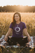 Purple crew-neck t-shirt with sun-and-moon graphic centered on chest