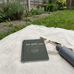 Quiet Life notebook on a garden blanket