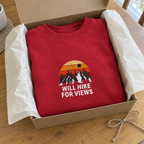 Red Will Hike for Views sweatshirt in an open gift box