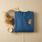 Royal blue crewneck sweatshirt with peace-sign hand embroidery on the chest