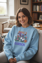 Personalized garden crewneck sweatshirt in light blue with floral graphic and “ROSES GARDEN”.