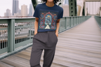 Graphic t-shirt worn by model: navy short sleeves with multicolor arch front print.
