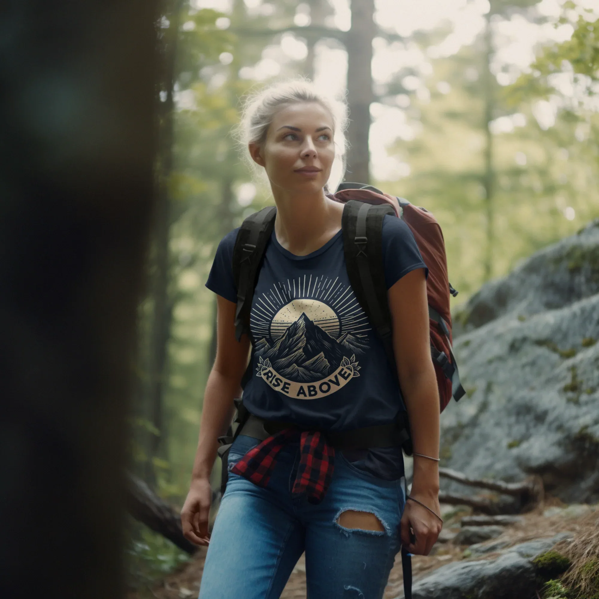 Black short-sleeve T-shirt with mountain sunrise “RISE ABOVE” graphic on hiker