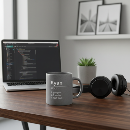 Ryan mug on desk with laptop and tech