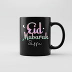 Black mug showing 'Eid Mubarak Saffa' text with crescent and stars.