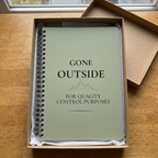 Sage green notebook inside a kraft gift box