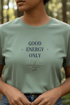 Sage green crew-neck T-shirt with dark “GOOD ENERGY ONLY” graphic on the chest