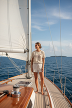 White T-shirt with #PROTECT THE OCEANS graphic worn on a boat deck
