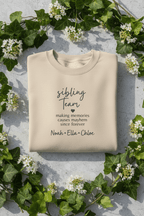 Sand crewneck sweatshirt with 'sibling Team' quote and names Noah, Ella, Chloe