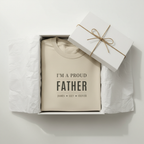 Beige folded dad T-shirt in gift box with 'I'M A PROUD FATHER' print