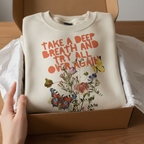 Sand crewneck sweatshirt featuring Take a Deep Breath text and colorful floral butterfly print