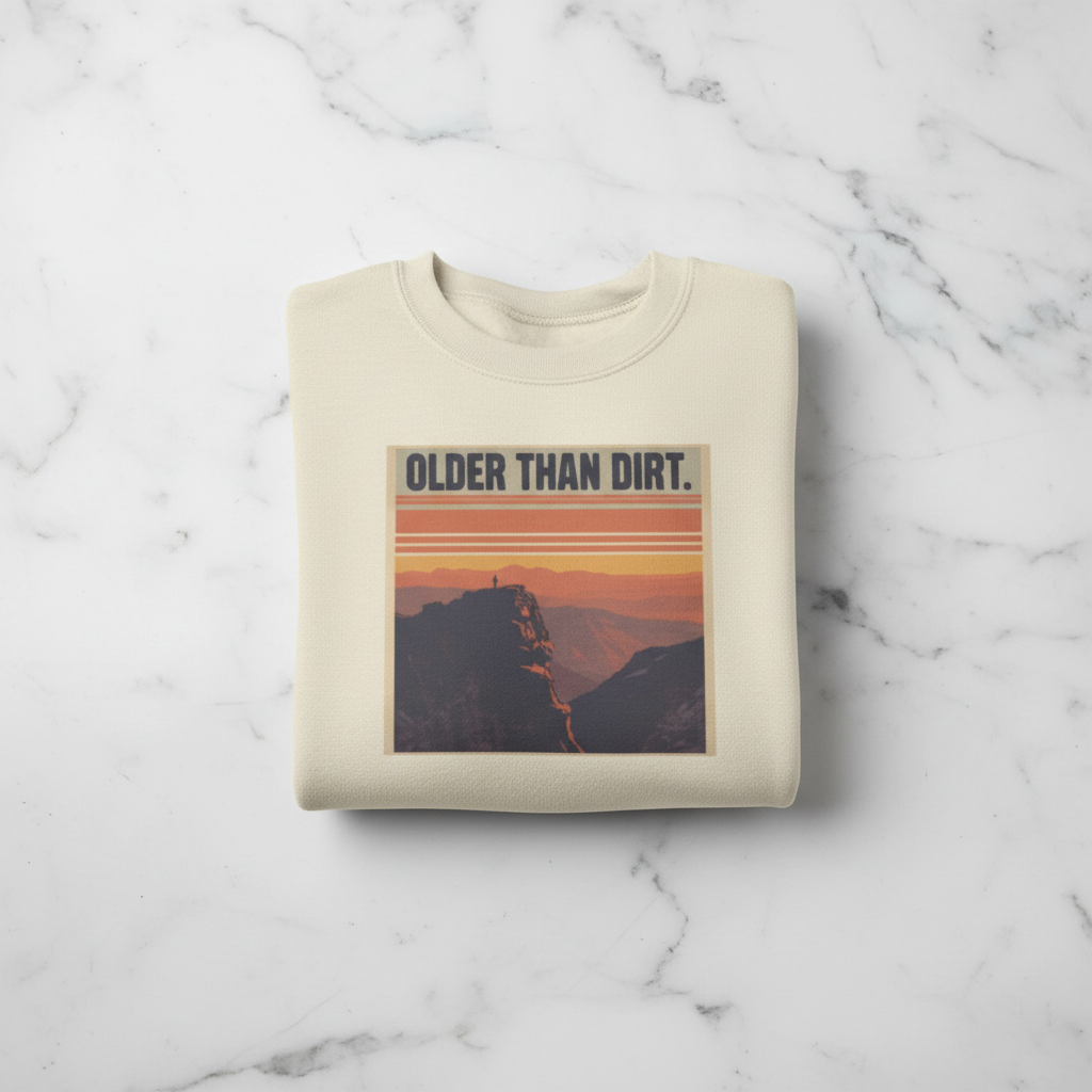 Sand crewneck sweatshirt with mountain sunset graphic and banner-style text