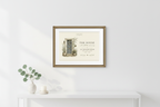 Framed canvas print featuring a small illustrated home with door, plants, and house text