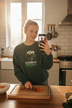 Dark green crewneck sweatshirt with tree graphic and 'Kindness Matters' text on chest