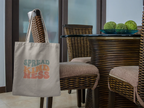 Light gray cotton tote bag with 'SPREAD KINDNESS' graphic on the front