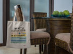 Light canvas tote bag with printed slogan and short handles