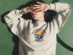 Light gray sweatshirt with crew neck and colorful space-themed graphic on chest.