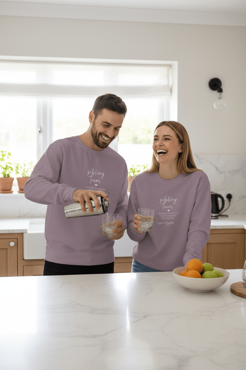 Lavender crewneck sweatshirt with long sleeves and white “sibling team” text print