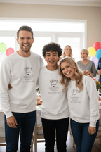 White crewneck sweatshirt with “sibling team” quote text printed on the chest