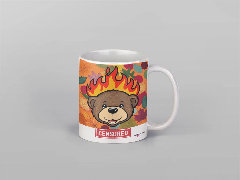 White ceramic bear mug with flames artwork and red “CENSORED” label, isolated front view.