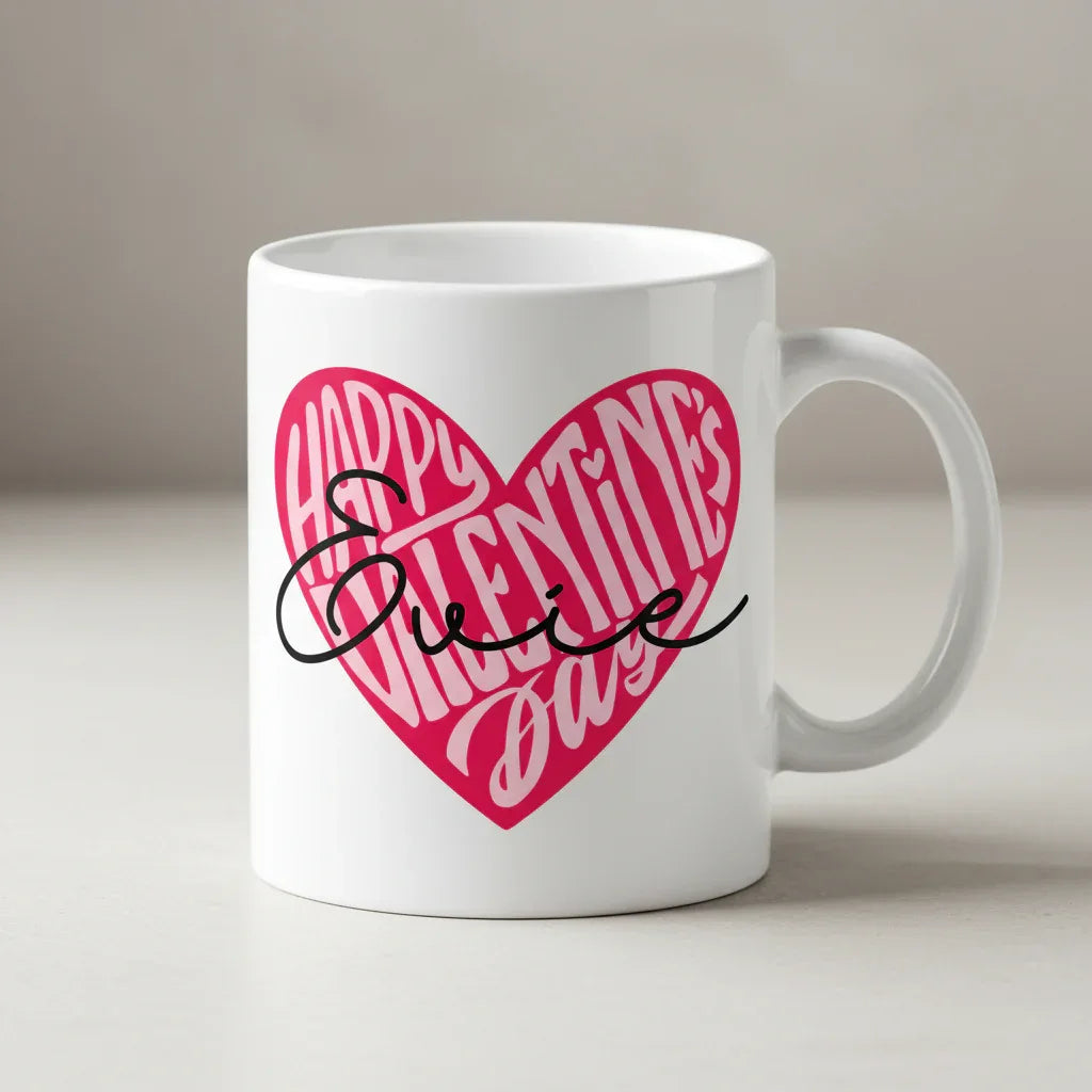 White ceramic mug with pink heart “Happy Valentine’s Day” logo