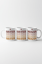 Set of three white mugs, with SISTER and MEGAN stacked text and heart icons