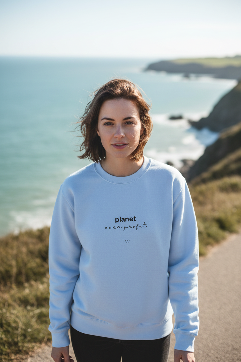 Light blue crewneck sweatshirt with centered chest logo and small heart