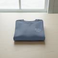 Blue crewneck sweatshirt with small chest text design