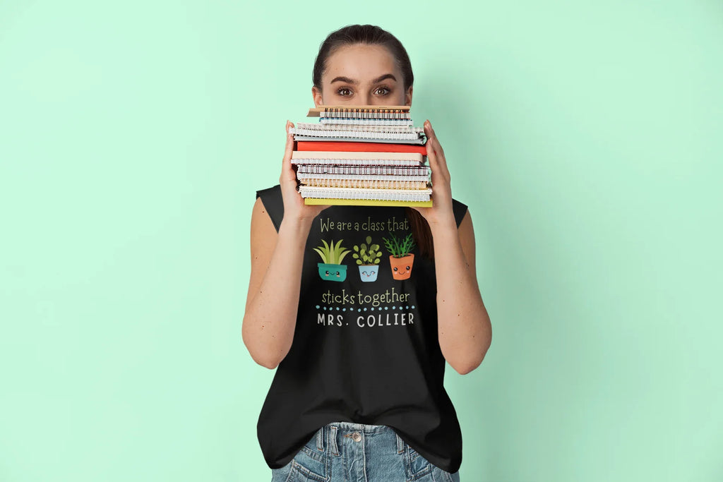 Black crewneck T-shirt with cartoon classroom icons and 'MRS. COLLIER' text.