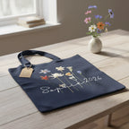 Navy cotton tote bag with wildflower print and "2026" date.