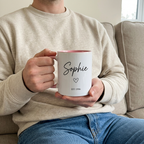 Sophie EST. 1996 pink mug held during a relaxed sofa cuppa