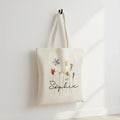 Navy cotton tote bag with dried wildflower illustration and name "Sophie".